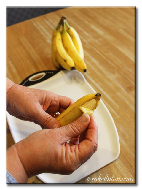 Close-up of hands peeling a banana