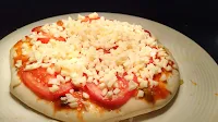 Mozzarella cheese topping over tomato on sauce spread pizza base for Margherita pizza Recipe