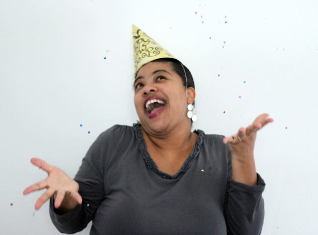 Happy New Year woman throwing confetti in the air