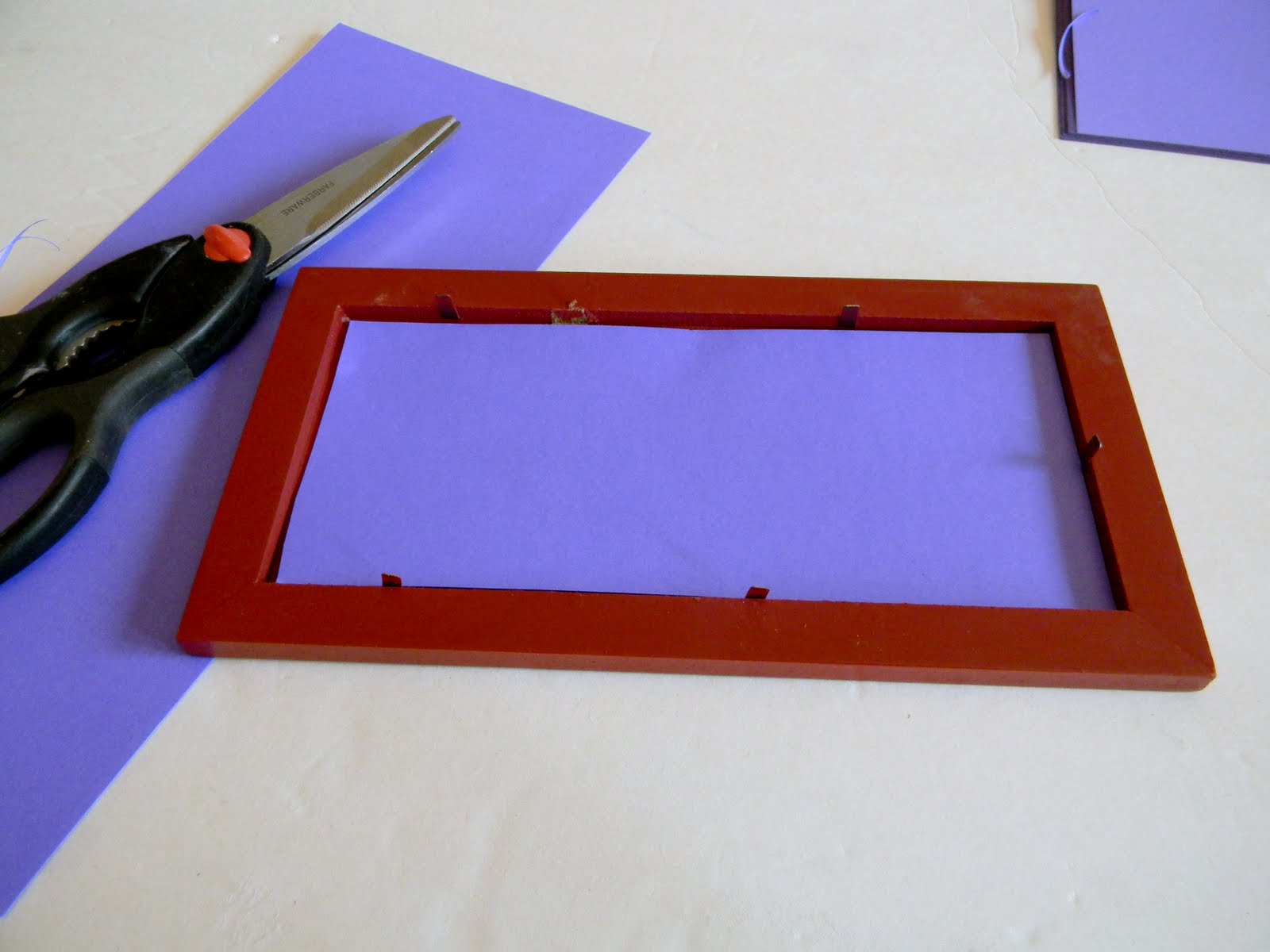 I cut card stock to match and slid it into the frame without the glass.