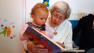grandmother reading to child