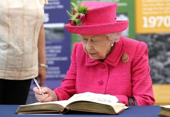 Queen Elizabeth wore a floral satin dress, pink coat and pink hat, pearl necklace, pearl earrings and diamond brooch