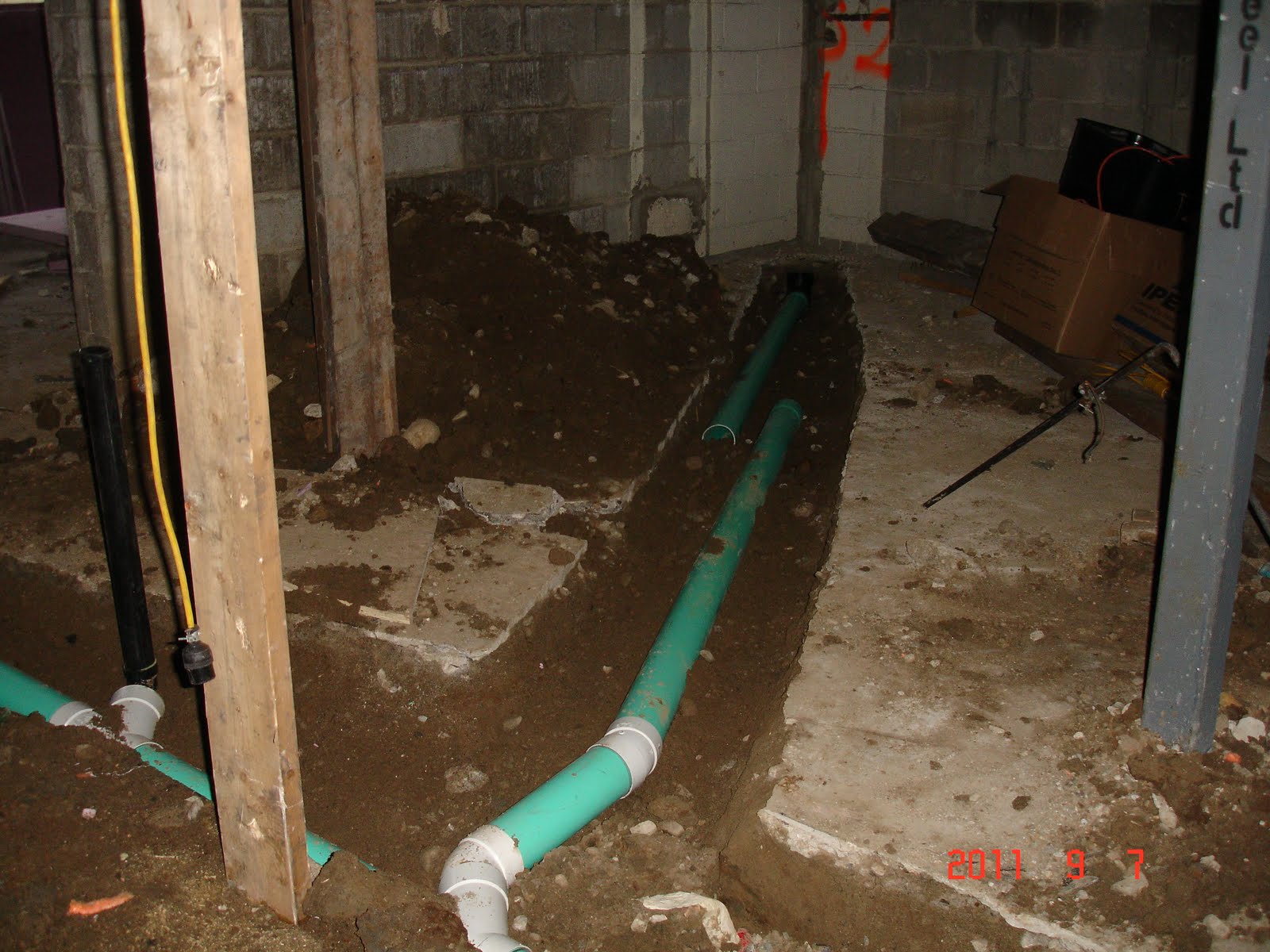 The Reno Coach Passive House Project in Toronto Drain pipes aere being layed in Basement Backup