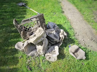 plastic crates milk jug cartons trash in yard dug up