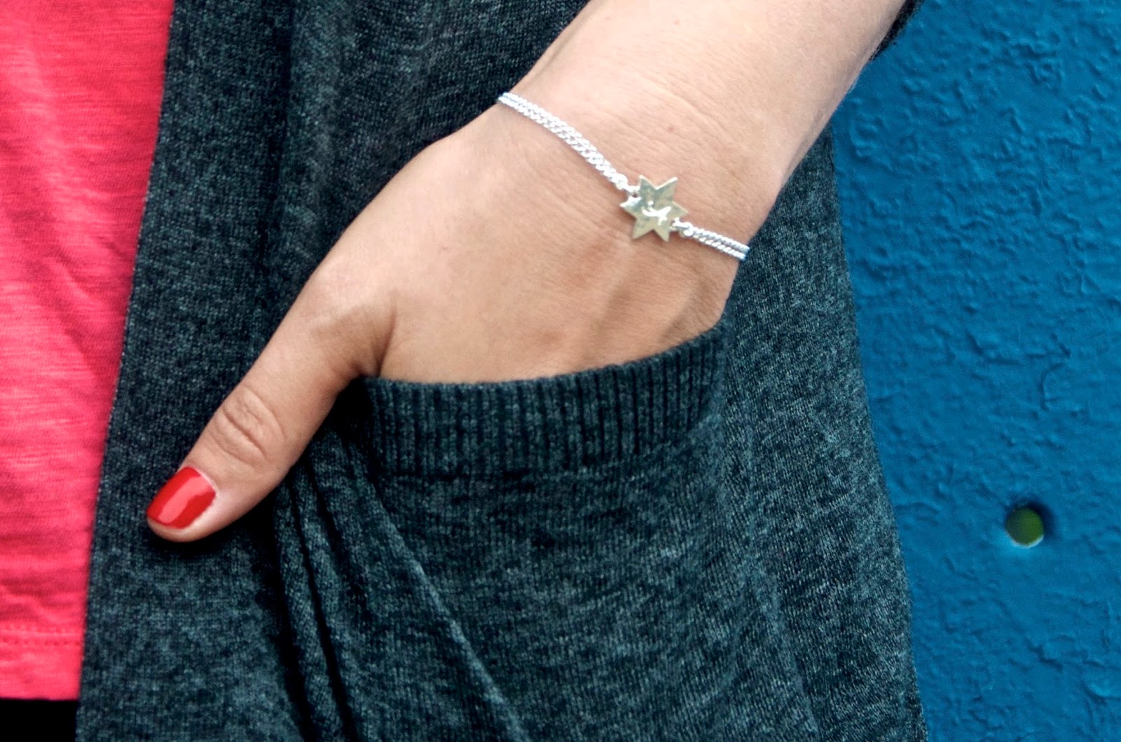 Sterling Silver Engraveable star bracelet, red manicure and gray cardigan