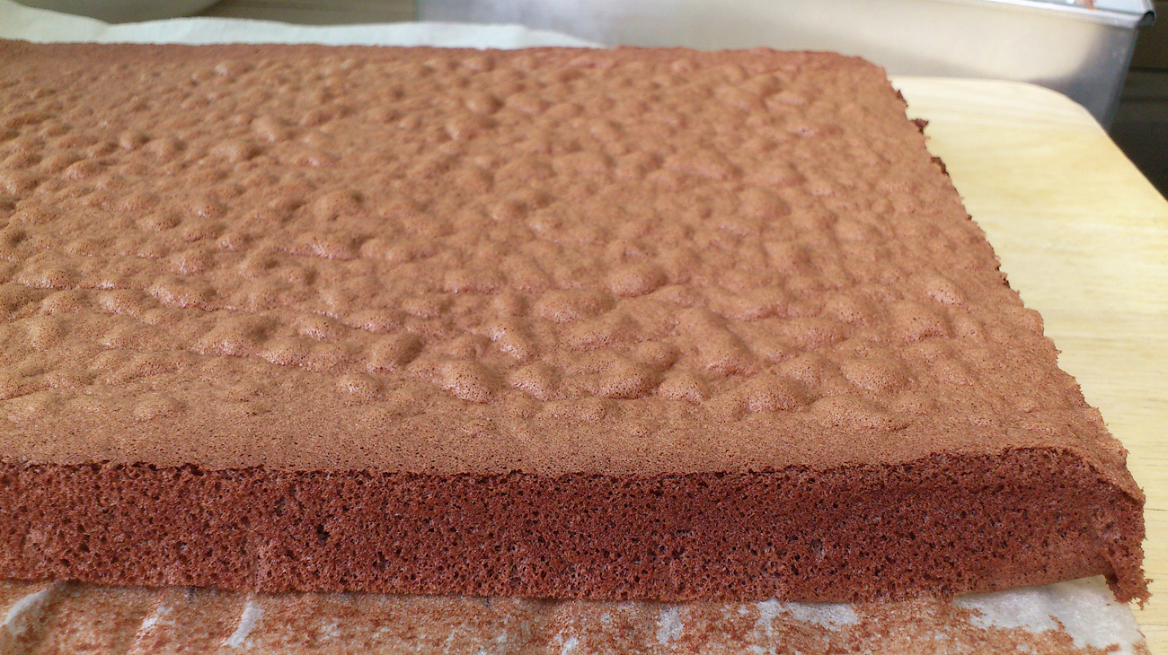chocolate sheet cake sitting on parchment paper