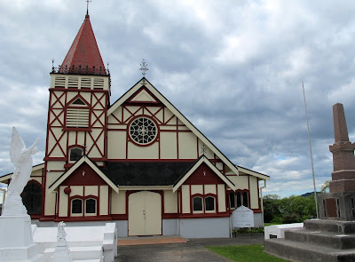 Front of a mock-tudor style wooden church.