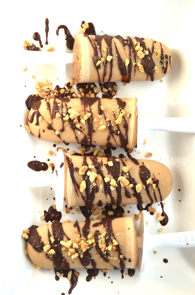 These Chocolate Peanut Butter Popsicles are  topped with drizzled chocolate and peanuts and are simple to make with only 6 ingredients! www.nutritionistreviews.com