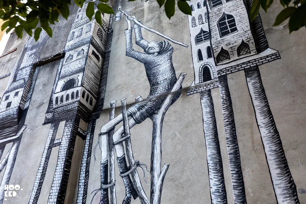 Black and white street art mural by UK artist Phlegm