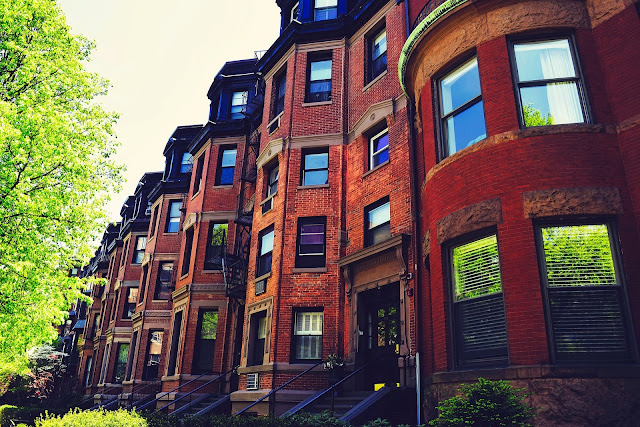 A row of connected brick houses. 