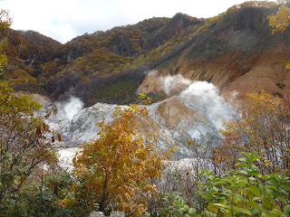 Jigokudani (Hell Valley) at noboribetsu onsen taken from a viewing area with some steam indicating it's geothermal activity