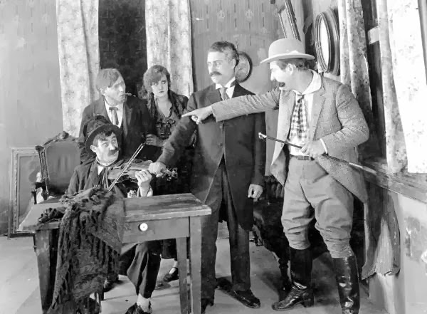 Motion picture scene from Strangled Harmony, 1916.  L-R: Bobby Burns, (?), Ethel Burton Palmer, (?), Walter Stull.