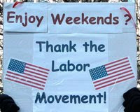 sign with 2 American flags saying, Enjoy weekends?  Thank the labor movement.