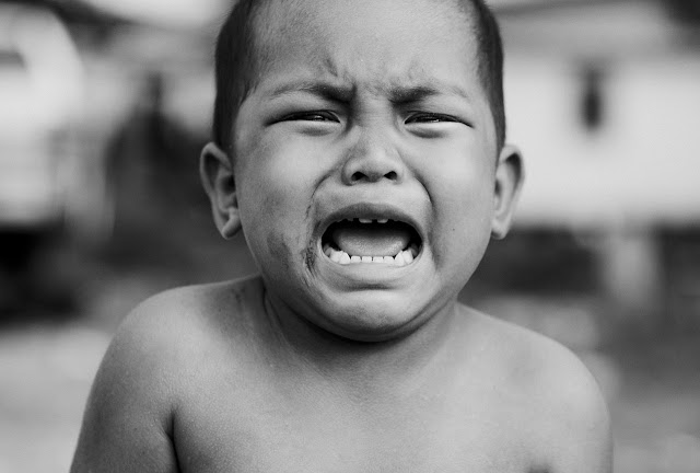 Young boy crying, angry