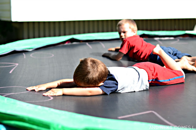 Learning how to tell the time on a trampoline using sidewalk chalk