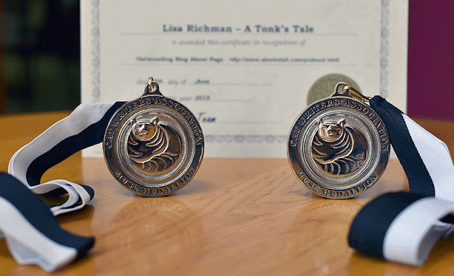 Our two Muse Medallions: Best Video, and Best Entertainment Blog