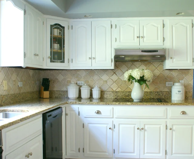 kitchen white cabinets stone countertops electric stovetop