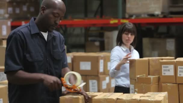 Depositphotos 25428501 Stock Video Male Factory Worker Sealing Packages