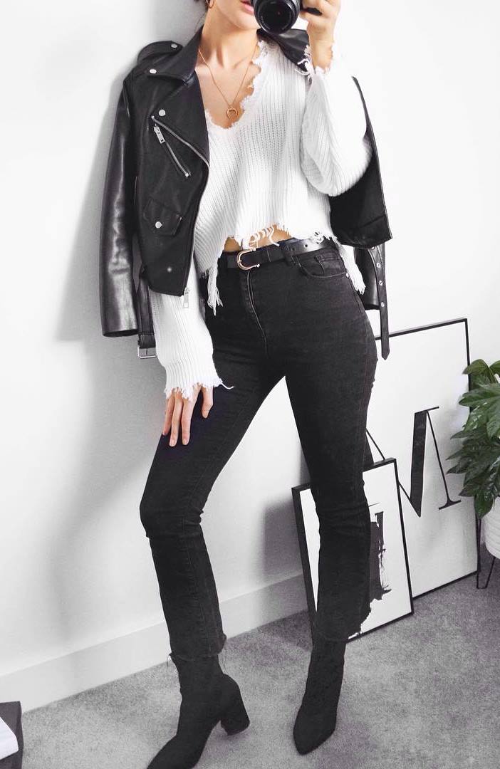 fall outfit idea with a white crop sweater : skinnies + boots + black moto jacket