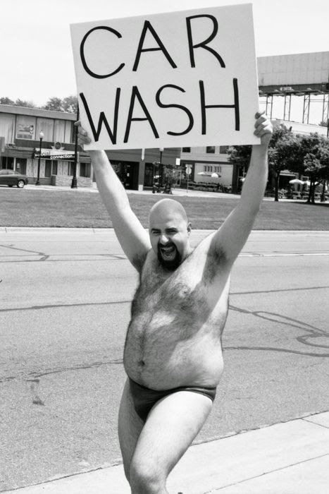 man advertising a car wash