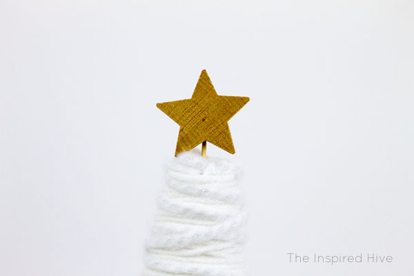 Make these easy and affordable DIY winter yarn trees to spruce up your winter decor! A great knock off idea to get the look for less! Get the tutorial at TheInspiredHive.com!