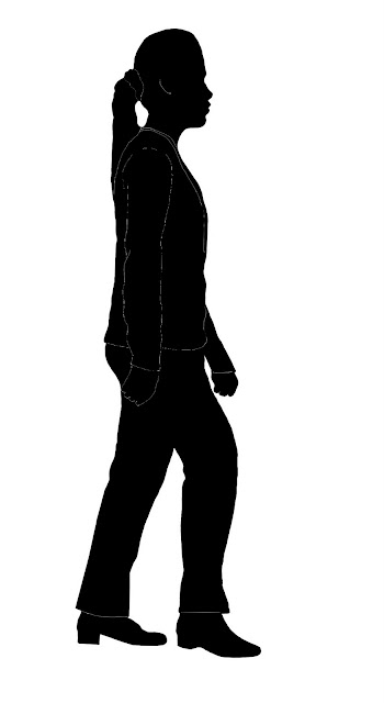 silhouette of woman in suit walking