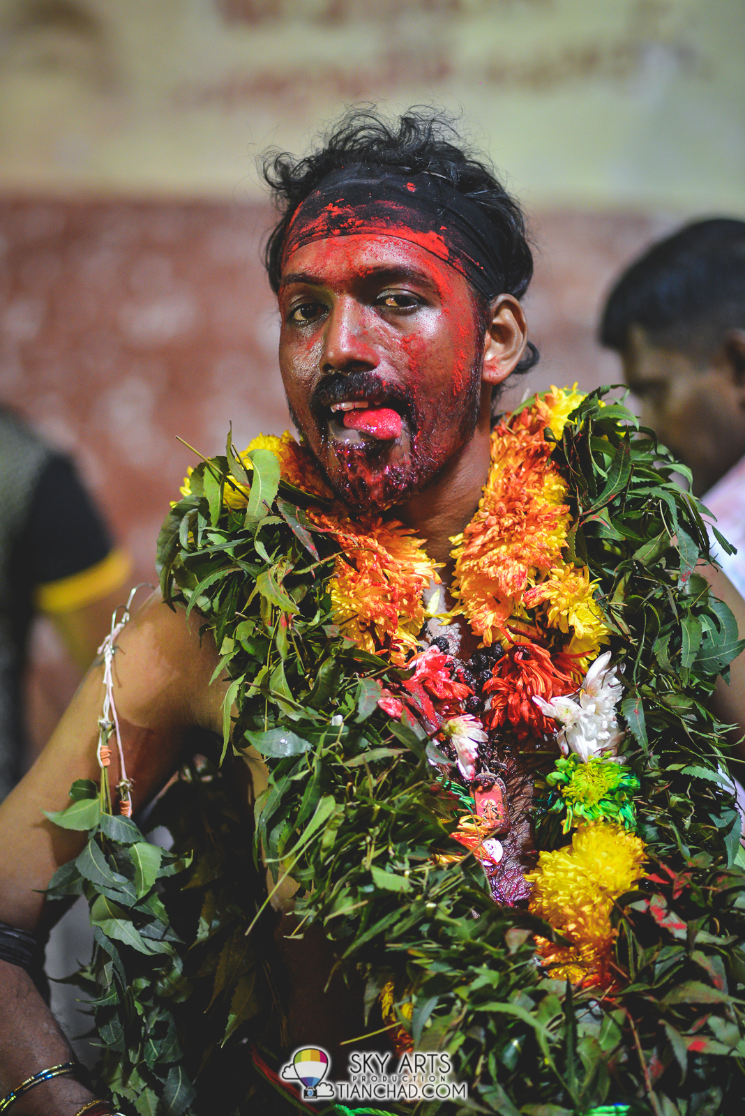 One of the devotee with red powder all over his face, not sure if it had mixed with the blood  at his chin