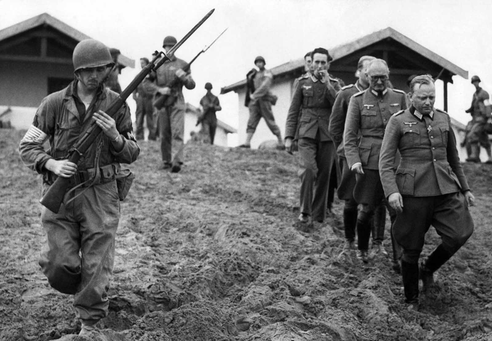 Under the watchful eyes of U.S. troops bearing bayonets, members of the Italo-German armistice commission in Morocco are rounded up to be taken to Fedala, north of Casablanca, on November 18, 1942. Commission members were surprised in American landing move.