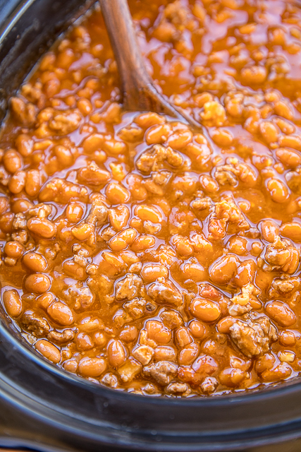 Slow Cooker Cowboy Beans - seriously the BEST baked beans I've ever eaten!!! Loaded with beef and bacon. SO easy to make! Great for potlucks and cookouts. Ground beef, bacon, onion, baked beans, ketchup, mustard, beef broth, garlic, brown sugar. I took these to a cookout and everyone asked for the recipe. A new favorite!! #slowcooker #bakedbeans #cookout #sidedish Slow Cooker Cowboy Beans - seriously the BEST baked beans I've ever eaten!!! Loaded with beef and bacon. SO easy to make! Great for potlucks and cookouts. Ground beef, bacon, onion, baked beans, ketchup, mustard, beef broth, garlic, brown sugar. I took these to a cookout and everyone asked for the recipe. A new favorite!! #slowcooker #bakedbeans #cookout #sidedish