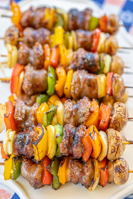 Grilled Bourbon & Coke Brats Skewers - SO good! Perfect party food!! Brats, onions, bell peppers and mushrooms marinated in bourbon, coke, soy sauce, brown sugar, seasoned salt and a little cayenne. Can assemble ahead of time and throw on the grill when you are ready to eat. These were a HUGE hit at our last tailgate. NO leftovers! A must for your next tailgate #tailgating #brats #grilling #partyfood Grilled Bourbon & Coke Brats Skewers - SO good! Perfect party food!! Brats, onions, bell peppers and mushrooms marinated in bourbon, coke, soy sauce, brown sugar, seasoned salt and a little cayenne. Can assemble ahead of time and throw on the grill when you are ready to eat. These were a HUGE hit at our last tailgate. NO leftovers! A must for your next tailgate #tailgating #brats #grilling #partyfood