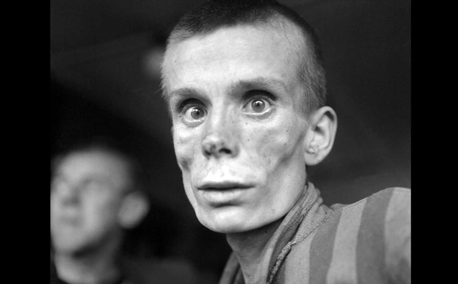 An emaciated 18-year-old Russian girl looks into the camera lens during the liberation of Dachau concentration camp in 1945. Dachau was the first German concentration camp, opened in 1933. More than 200,000 people were detained between 1933 and 1945, and 31,591 deaths were declared, most from disease, malnutrition and suicide. Unlike Auschwitz, Dachau was not explicitly an extermination camp, but conditions were so horrific that hundreds died every week.