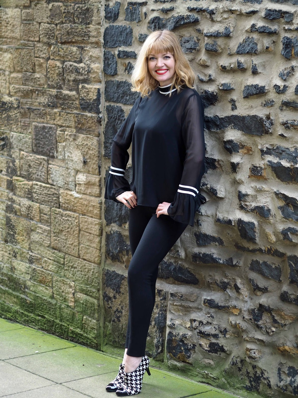 What Lizzy Loves black and white tipped blouse with bell sleeves, black and white hounds tooth shoe boots