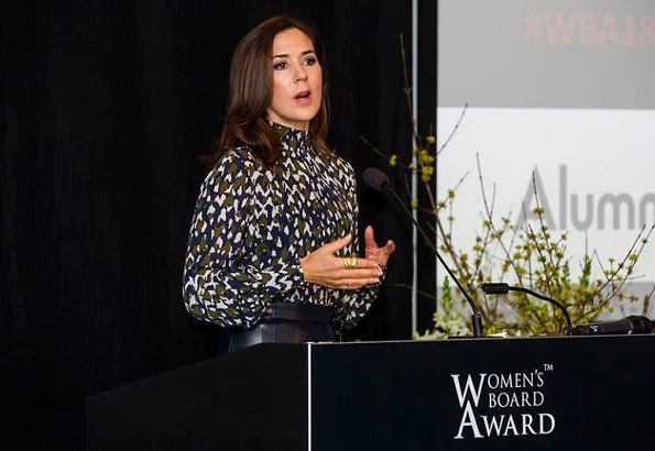 Danish Crown Princess Mary to the winner of the award, CSM's President Marianne Kirkegaard. Princess Mary wore leather skirt and print blouse