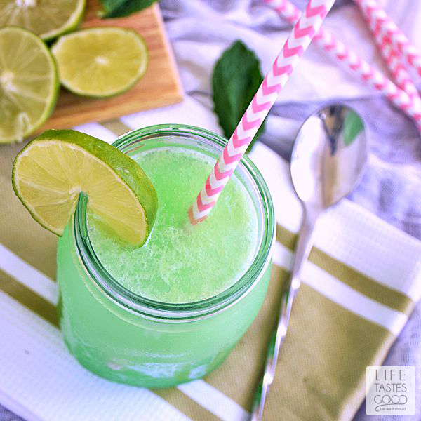 This Mojito Slush recipe | by Life Tastes Good is a mix of frozen limeade, grapefruit soda, fresh mint, and rum. The combination of sweet refreshing citrus and mint flavors with a little kick of rum is a popular summer cocktail. Perfect for a pool party!