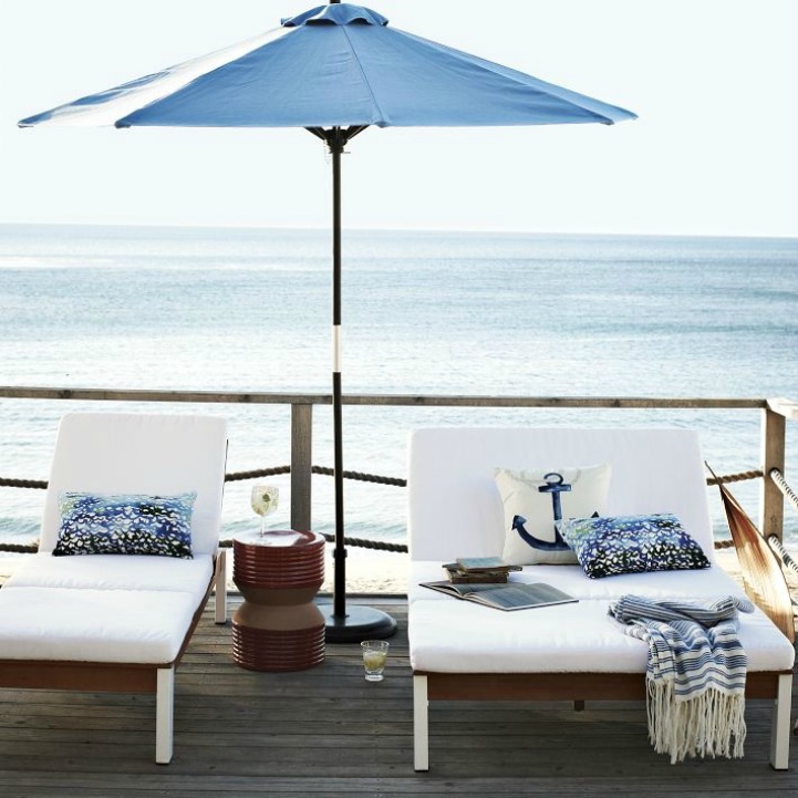 Coastal outdoor space with sun loungers and umbrella