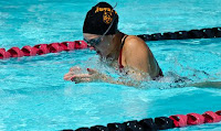 Better Breaststroke Image of a female swimmer doing breaststroke in a pool lane: thia artical is about How To Swim Better Breaststroke