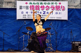 A belly dancer doing her motions on a festival stage