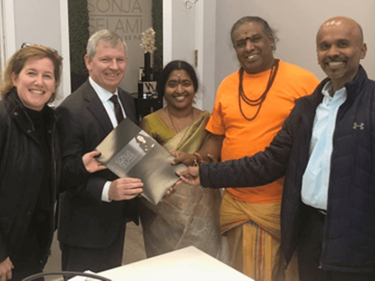 At the real estate closing (L–R) are Nicole Shannon, the property seller’s attorney; Christopher Nichols, the Temple’s attorney; Mrs. Mangalam Sambamoorthy, Temple President; Sivachariar Bhairavasundaram Muthubattar, Temple priest; and congregation member Muthu Meyyappan. (Photo courtesy: Bellingham Bulletin)