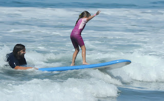 Camper Alex learns to surf with camp counselor Matt Duda at Aloha Beach Camp in Los Angeles.