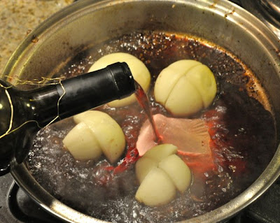 Red wine crock pot beef roast red wine being poured in to pan