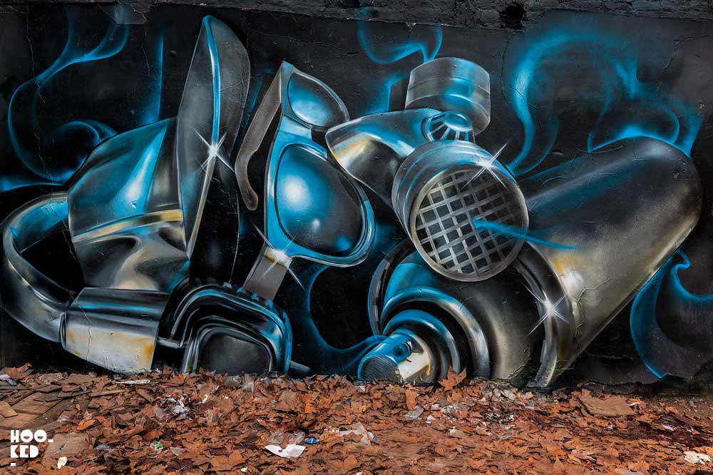 London street artist Fanakapan paints a mural in East London's Star Yard car park.