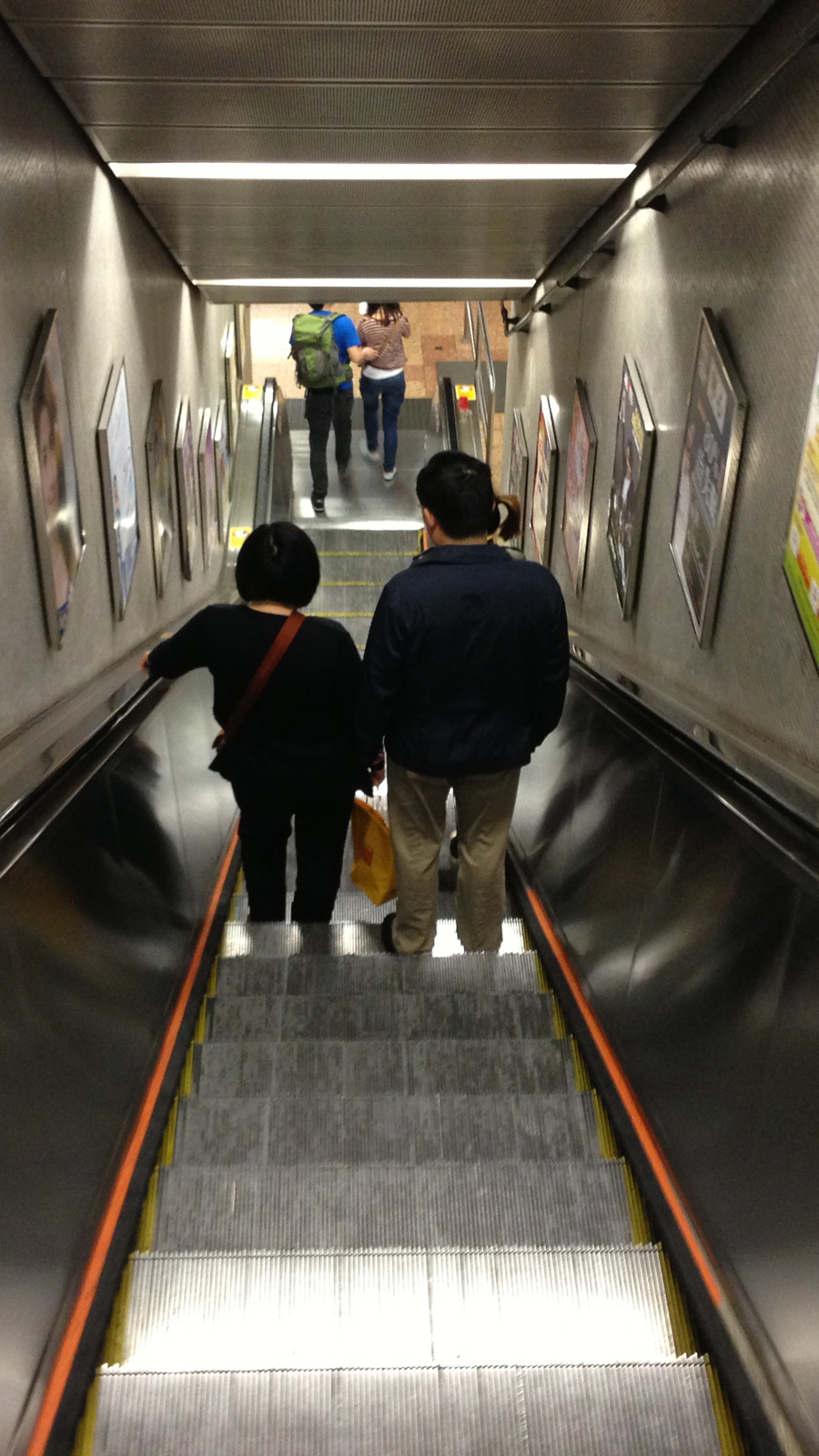A couple heads down the MTR station in Mong Kok.