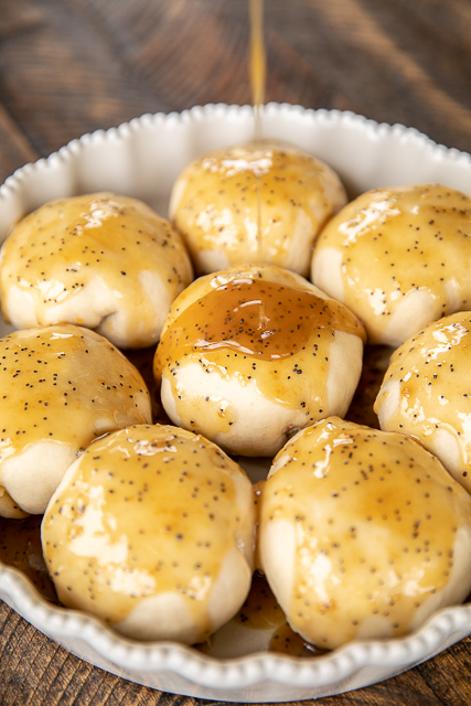 Glazed Breakfast Biscuit Bombs - the best way to start the day! Biscuits stuffed with scrambled eggs, bacon and cheese and topped with a sweet and savory glaze. We make these at least once a month! Refrigerated biscuits, milk, eggs, bacon, cheddar cheese, butter, brown sugar, dijon mustard, Worcestershire sauce and poppy seeds. A great dish for breakfast, brunch and overnight guests! #breakfast #biscuits Glazed Breakfast Biscuit Bombs - the best way to start the day! Biscuits stuffed with scrambled eggs, bacon and cheese and topped with a sweet and savory glaze. We make these at least once a month! Refrigerated biscuits, milk, eggs, bacon, cheddar cheese, butter, brown sugar, dijon mustard, Worcestershire sauce and poppy seeds. A great dish for breakfast, brunch and overnight guests! #breakfast #biscuits