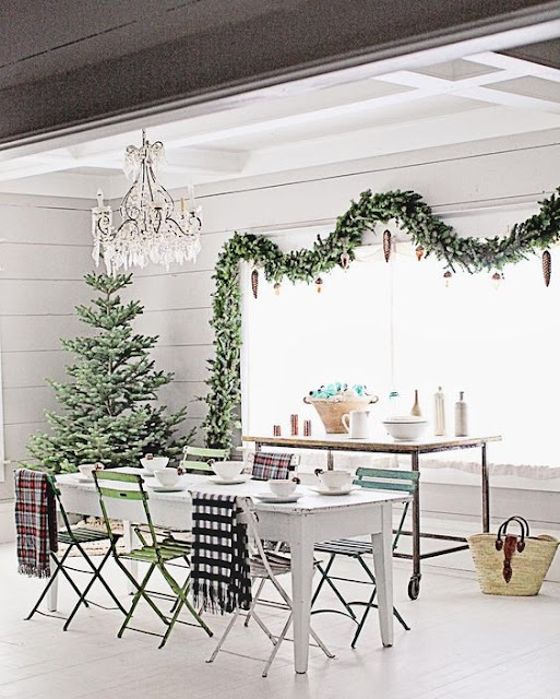 White farmhouse table with fresh greenery and chandelier Farmhouse Christmas holiday decorating shabby chic