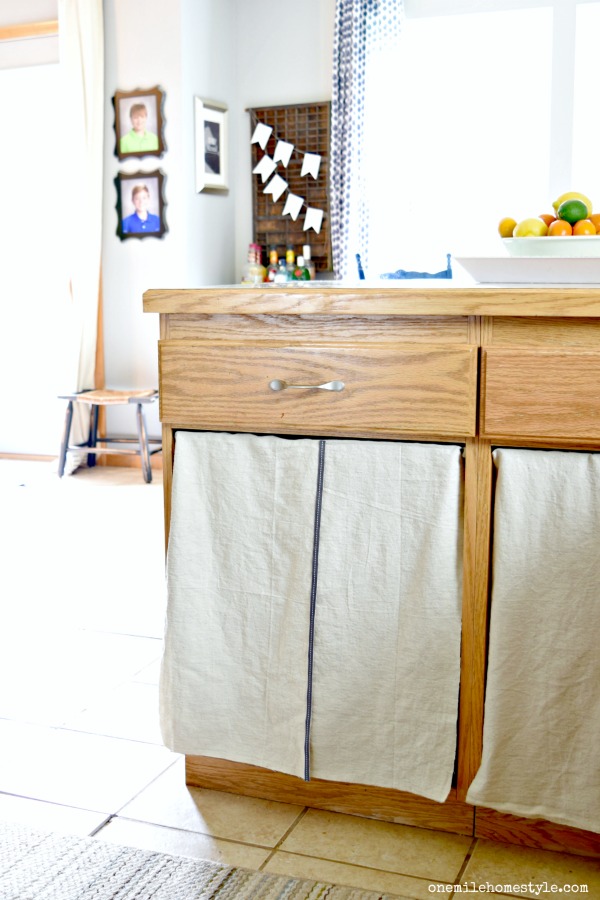 Hide ugly kitchen cabinets with these DIY cabinet curtains made from a drop cloth!