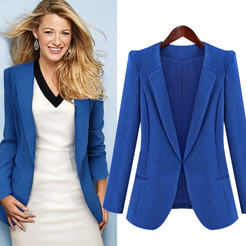 A woman wears a white skirt and puts on a blue suit.