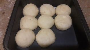 place-the-dough-balls-into-the-greased-baking-pan