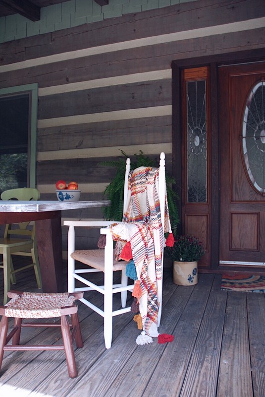 Fall_porch_decor_log_cabin_chair_plaid_throw