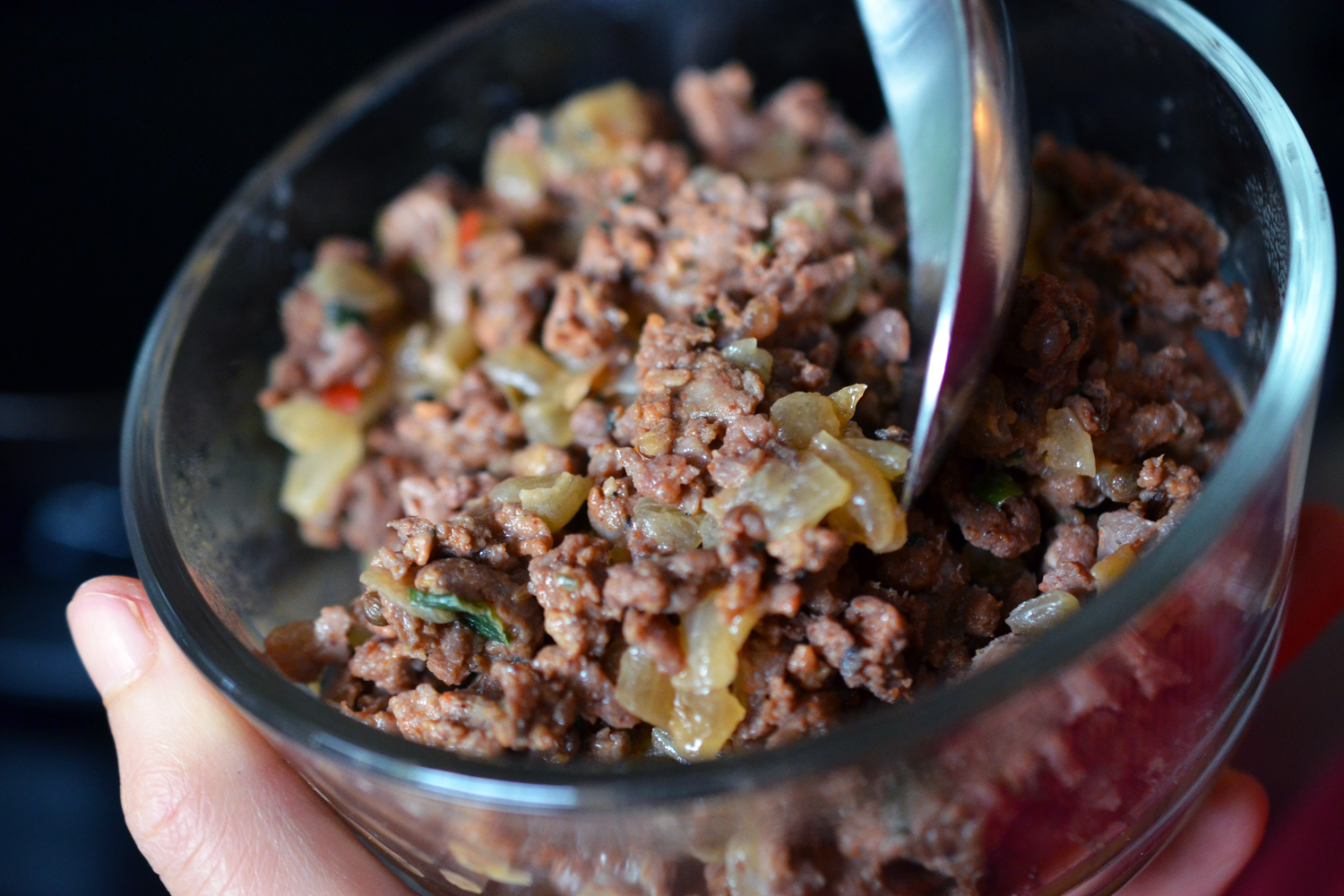 A close-up of a bowl of leftover cooked meat lamb sausage in a bowl.