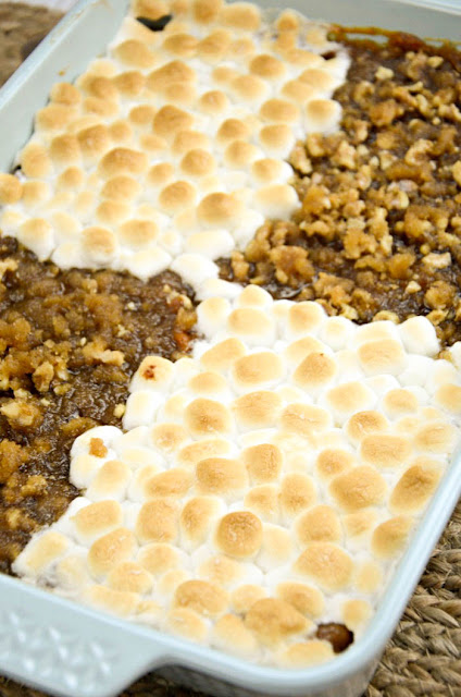 His and Her Sweet Potato Casserole, two Thanksgiving traditions come together, toasted marshmallows and pecan crumble toppings blanket creamy smooth sweet potatoes.  Scrumptious!!